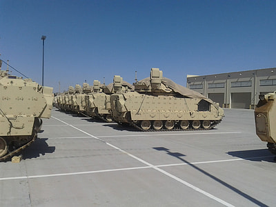 parked war tanks near building thumbnail