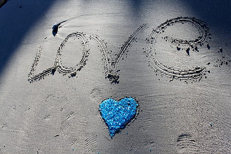 Love illustration on sand during daytime thumbnail