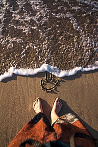 woman standing on seashore during daytime thumbnail