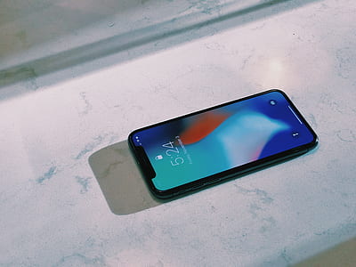 silver iPhone X on top of white marble surface thumbnail