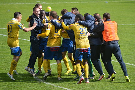 soccer team players standing on field at daytime thumbnail