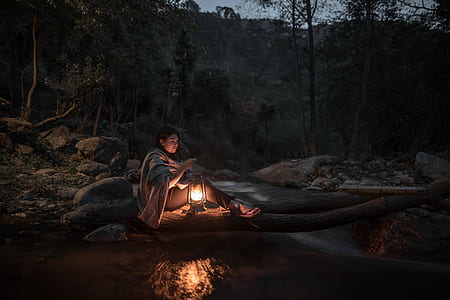 woman wearing gray shawl holding a lighted lamp thumbnail
