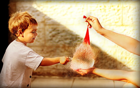 boy wearing white shirt popping a red water balloon thumbnail