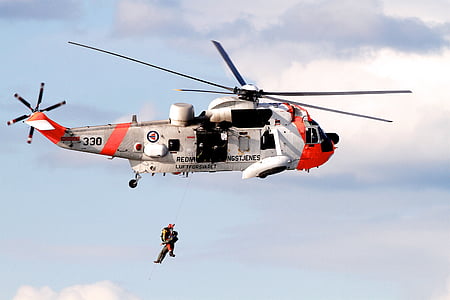 person hanging front rescue helicopter thumbnail