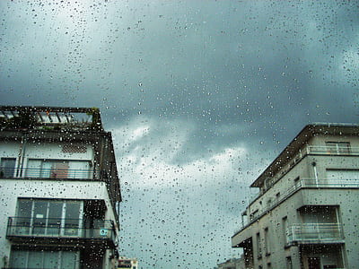 white house drenched with rain under gray skies thumbnail