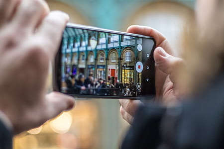 person taking photo of structure thumbnail