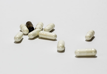 oval white and black medicine pill lot thumbnail