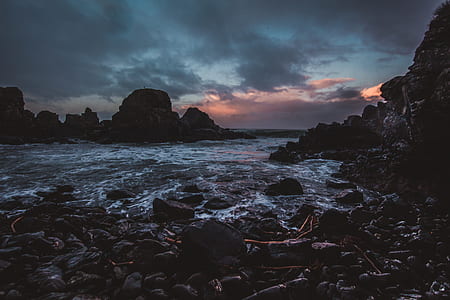 water splashing on brown rocks thumbnail