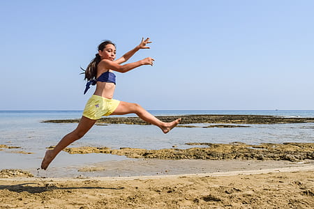 woman jumping on seashore thumbnail