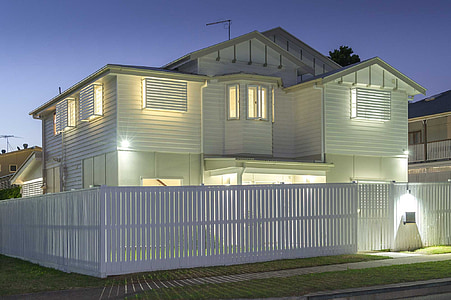 white wooden house with lights turned-on thumbnail