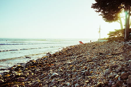 photo of rock peebles on seashore beside sea thumbnail