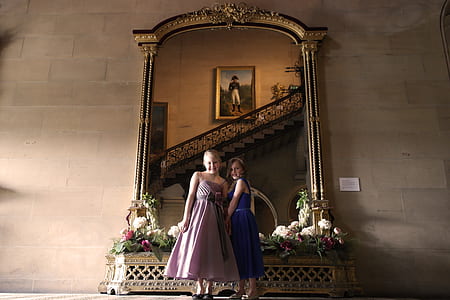 two girls standing near wall mount mirror thumbnail