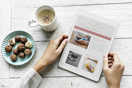 Person Holding White Tablet Beside White Ceramic Mug thumbnail
