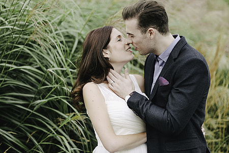 man and woman stancing to kiss beside green grass plant thumbnail