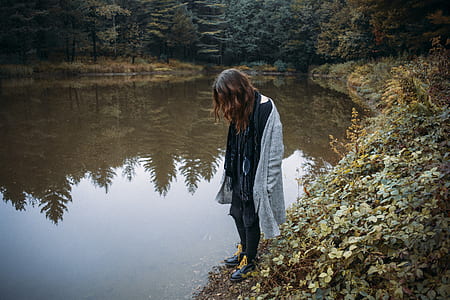 person standing near river bank thumbnail