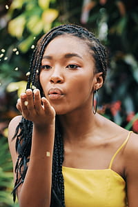 woman blowing yellow flowers thumbnail