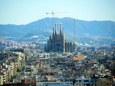 high rise buildings near mountain thumbnail