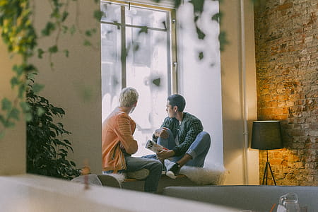 Two Men Near the Window Talking thumbnail