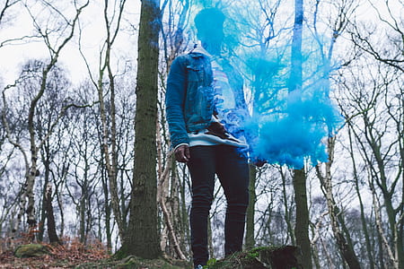 person wearing blue jacket and black pants thumbnail