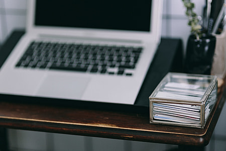 Elegant workspace with Macbook, iPhone, business cards and notebooks thumbnail
