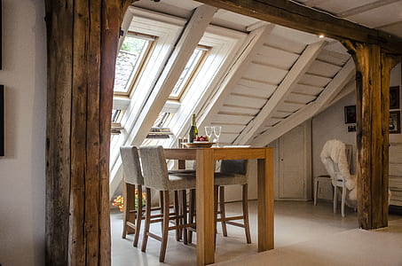 square beige wooden table beside window thumbnail