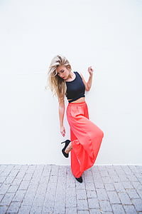 woman looking at her heeled shoes near wall thumbnail