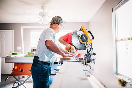 man using saw inside room thumbnail