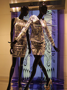 two black mannequins wearing yellow and multicolored long-sleeved shirts thumbnail