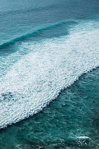 body of water with waves during daytime thumbnail