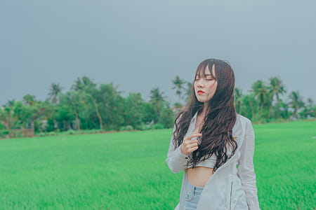 Woman Wearing Gray Cardigan on Green Grass thumbnail