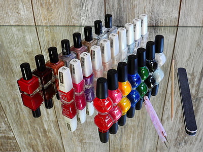 line up assorted-color nail lacquer bottles beside nail tools thumbnail