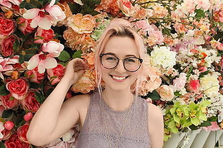woman standing in front of flowers thumbnail