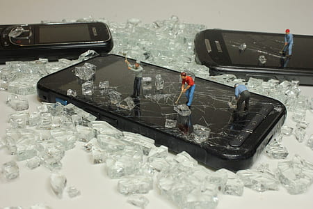 black iPhone 5 on glass shards thumbnail
