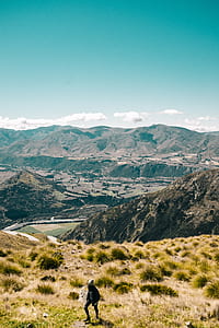 person walking on mountain during daytime thumbnail