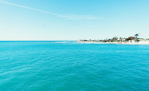 white beach on body of water thumbnail