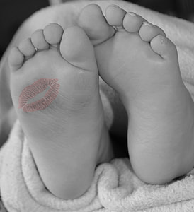 selective color photography of red kiss mark on foot thumbnail
