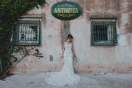 woman leaning on red concrete wall thumbnail