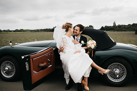 newly weds on black coupe during daytime thumbnail