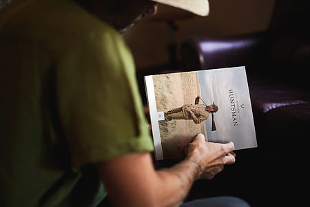 man holding Huntsman book thumbnail
