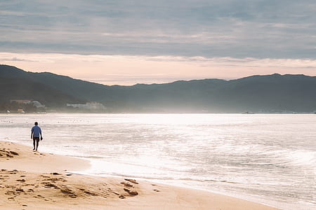 silhouette of person standing at seashore thumbnail