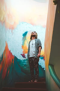 man standing near blue water waves paunting thumbnail