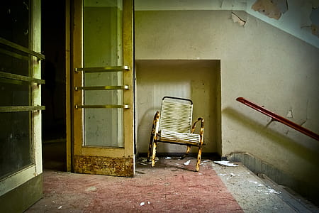 brown armchair near door and stairs thumbnail