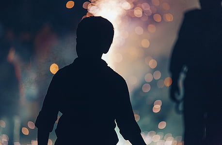 silhouette photo of boy with bokeh background thumbnail
