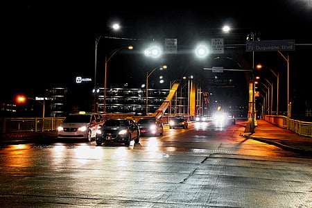 vehicles arriving on concrete road during nighttime thumbnail
