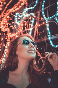 Woman Wearing Sunglasses Holding Her Hair thumbnail