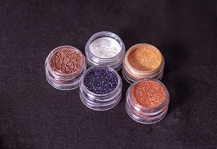 Close-Up Photo of Glitters on Round Containers thumbnail