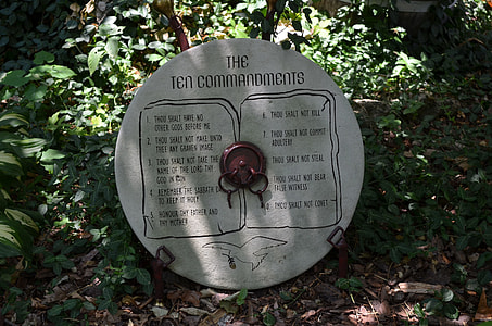 round The Ten commandments tablet near green plants during daytime thumbnail