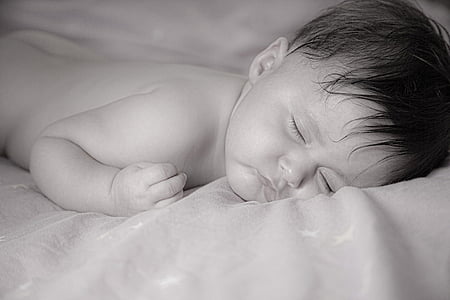 grayscale photo of boy sleeping on surface thumbnail