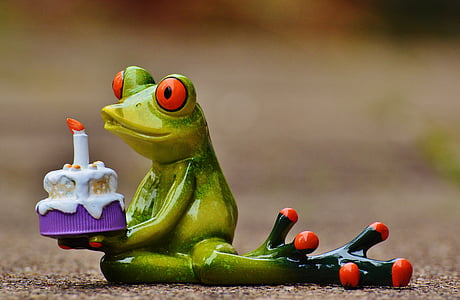 frog holding cake figurine thumbnail