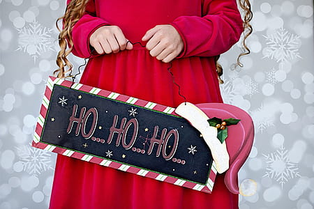 person in red long-sleeved dress holding white and red photo frame thumbnail